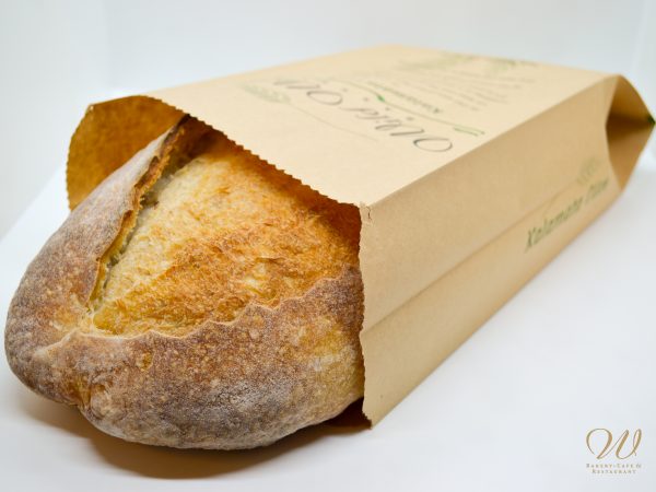 Wild Wheat kalamata olive bread in a paper bag